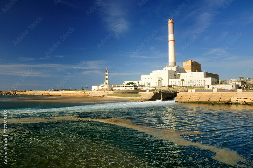 Fototapeta premium View to massive power station in old Tel Aviv port with sea water at the foreground. 