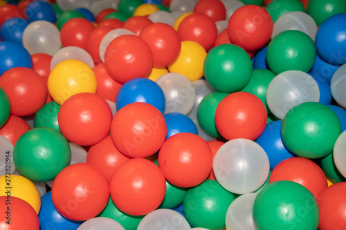 Balls for a dry pool background. Background of many colored plastic balls. Baby Delight Bright colored balls. Plastic balls