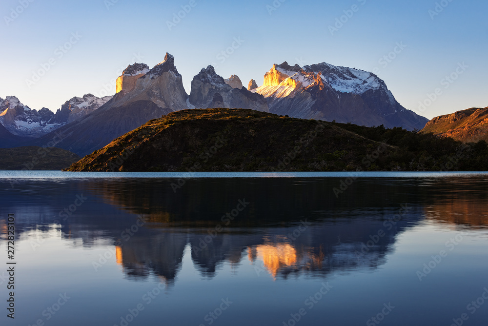 Fantastic mountain landscape. Reflection of mountains in the lake. Sunset view. National Park Torres del Paine, Chile.