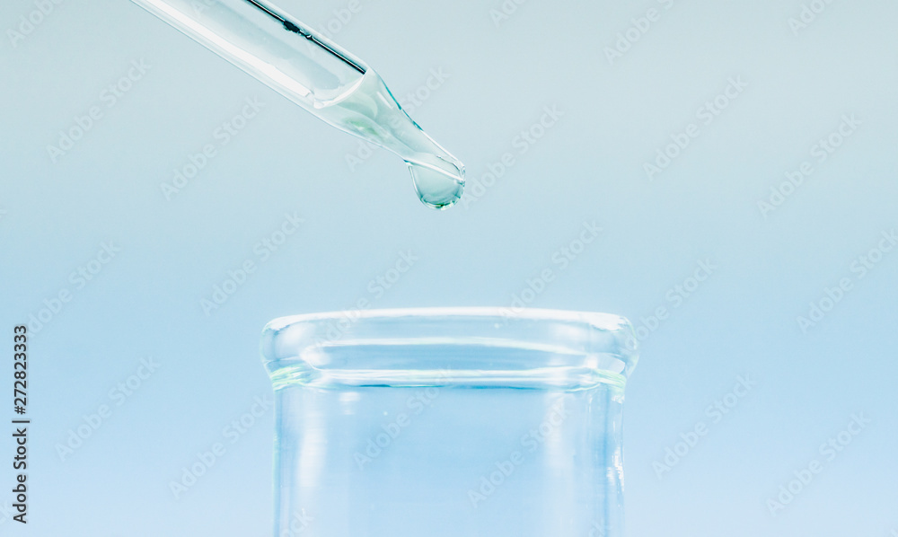 Pipettes take samples to a test tube containing chemicals. Pipettes take samples to a test tube containing chemicals.