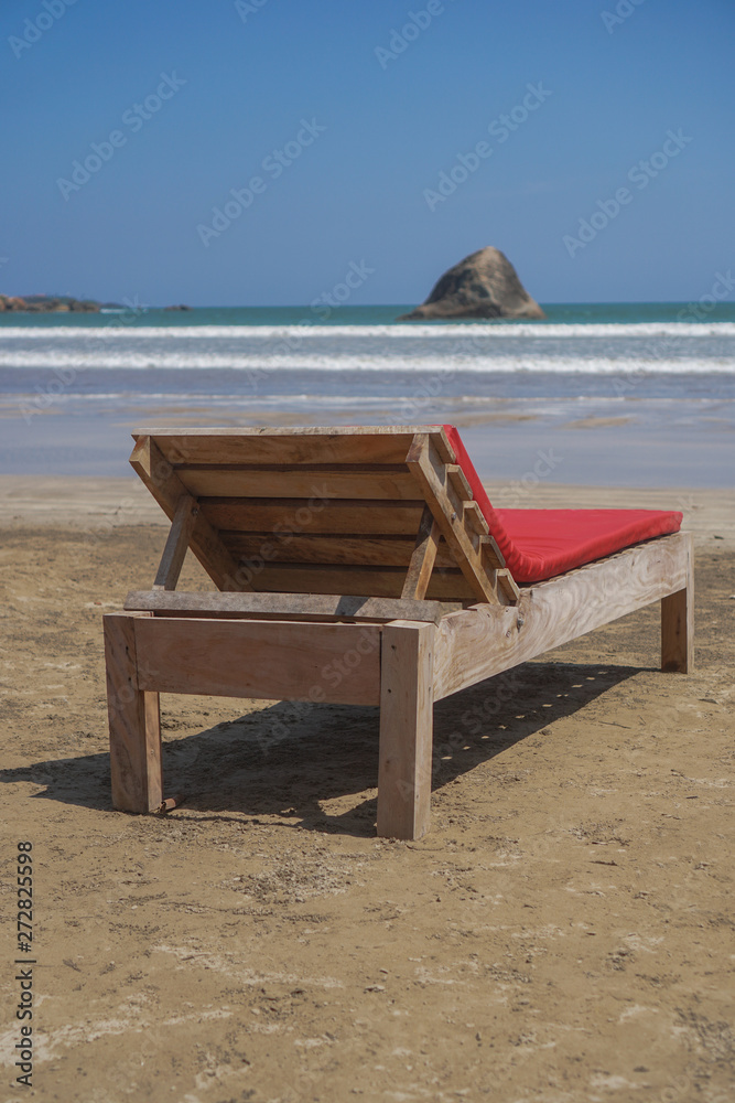Beautiful Sri Lankan view of the Indian Ocean with sun loungers on the beach. Summer holidays in Asia. Stock photos Beautiful Sri Lankan view of the Indian Ocean with sun loungers on the beach. Summer holidays in Asia. Stock photos