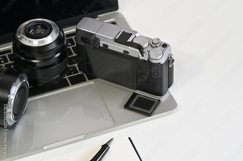 Photographer desk with camera, lens, laptop and memory. Photographer desk with camera, lens, laptop and memory.
