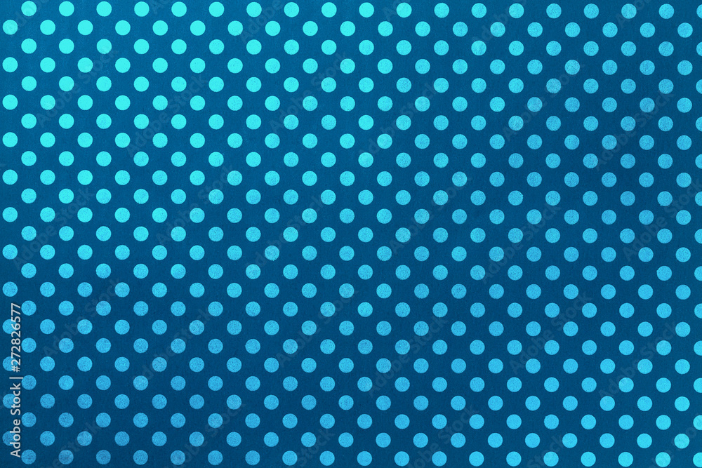 Navy blue background from wrapping paper with a pattern of turquoise polka dot closeup.