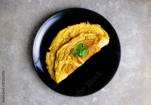 Omelette with tomatoes slide, coriander and scallion.