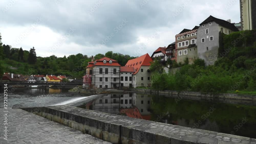 Cesky Krumlov city captured bridge with flowing Vltava river at riverbank during spring day in slow motion at 120 FPS Cesky Krumlov city captured bridge with flowing Vltava river at riverbank during spring day in slow motion at 120 FPS