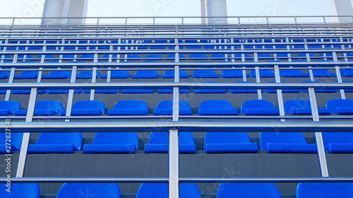 Blue plastic seats. Free arena seating. Empty plastic chairs seats for football fans.