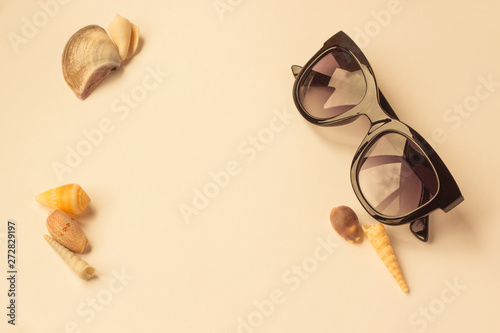 Flat lay traveler accessories on yellow background with black sunglasses. Top view travel or vacation concept. Summer background