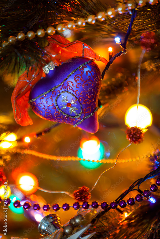 Beautiful blue purple heart hanging on Christmas tree close-up