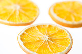 Three dried orange slices isolated on white background - selective focus