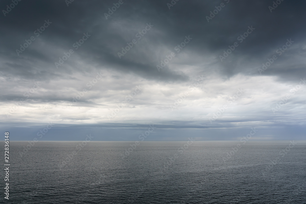 cloudy calm seascape with dark clouds