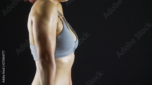 4K fitness girl shoulder shrugs strength training