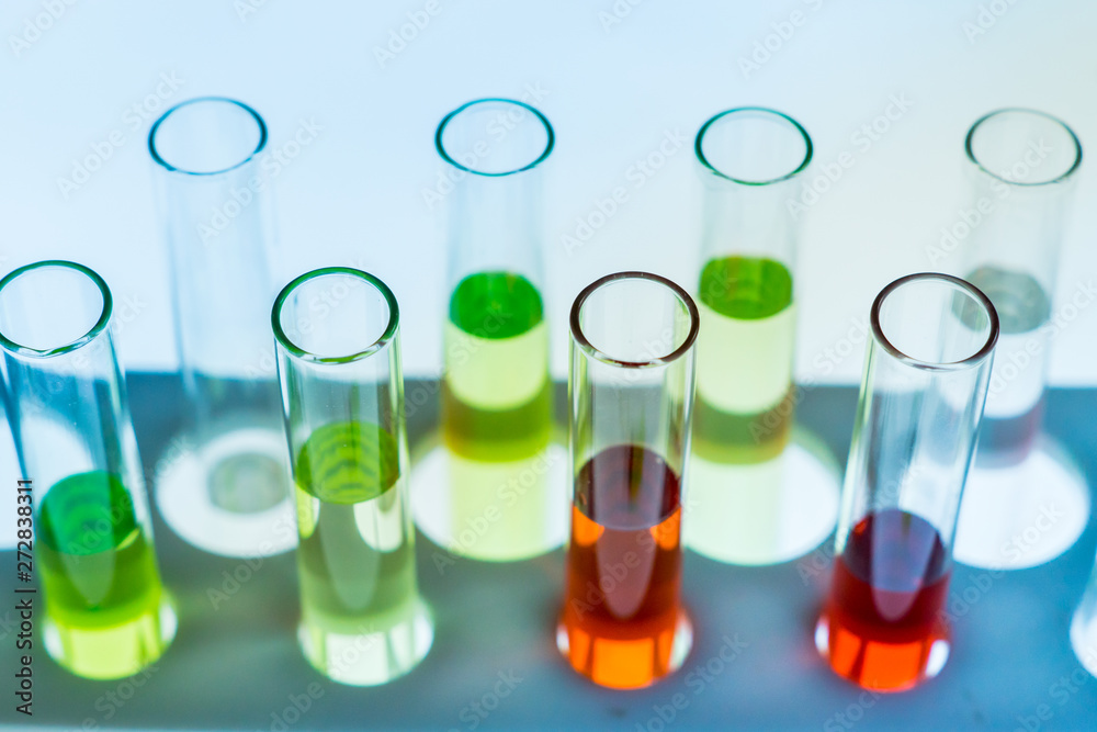 Multiple test tubes packed with chemicals, close-ups, background Multiple test tubes packed with chemicals, close-ups, background