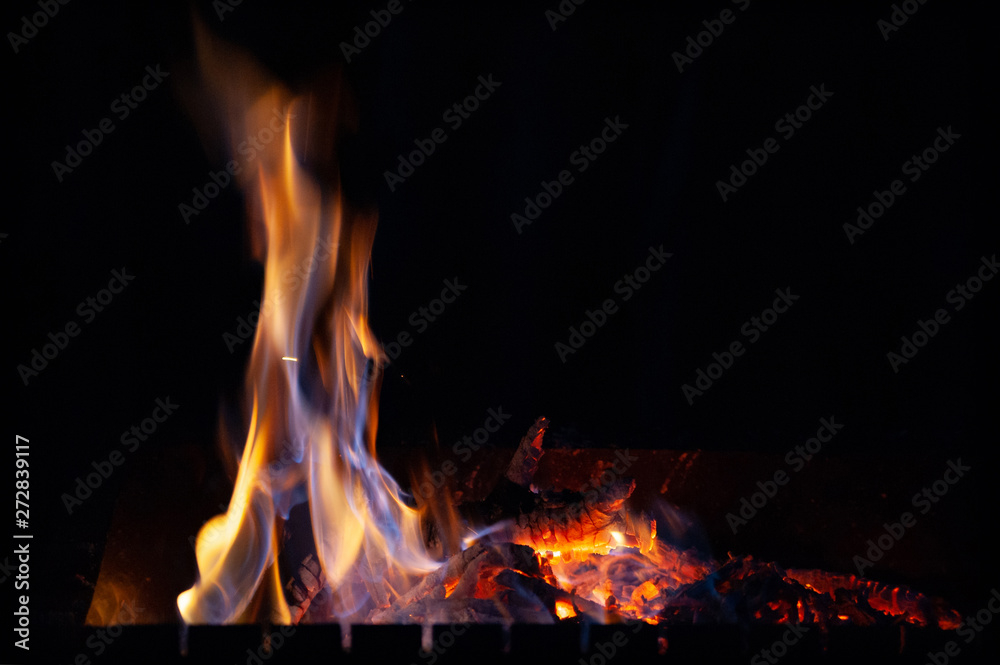 Close-up fire bonfire. The flame of fire burns in an open furnace at night. Close-up fire bonfire. The flame of fire burns in an open furnace at night.