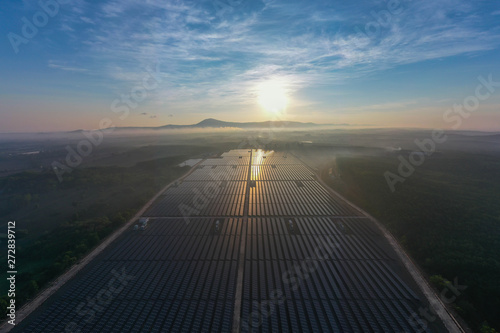 Aerial view of Solar Farm when sunrise and sunshine. Alternative energy.