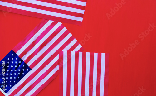 American flags for USA symbol on red background. Fourth of July or Memorial Day concept with copy space.