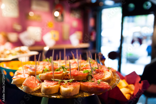Photography close up of italian style happy hour with italian food and tapas above table ind