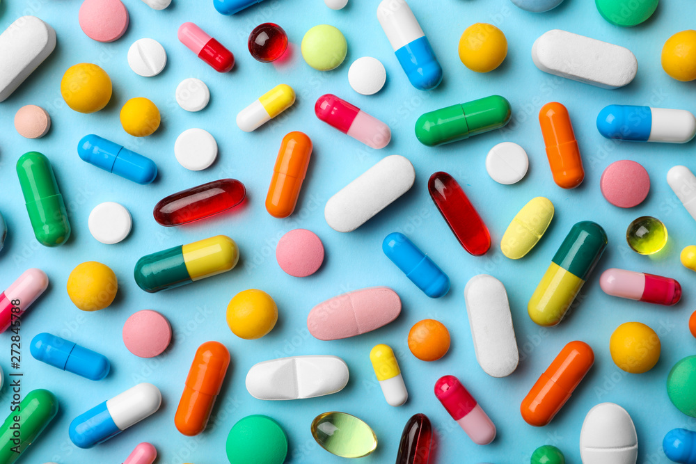 Different pills on color background, flat lay Different pills on color background, flat lay