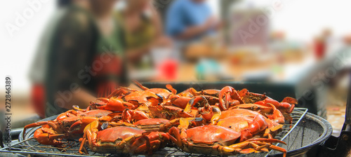 Close-up of shot grill crab on flaming Charcoal fire grill. Barbecue party on seaside. BBQ, Seafood party concept.