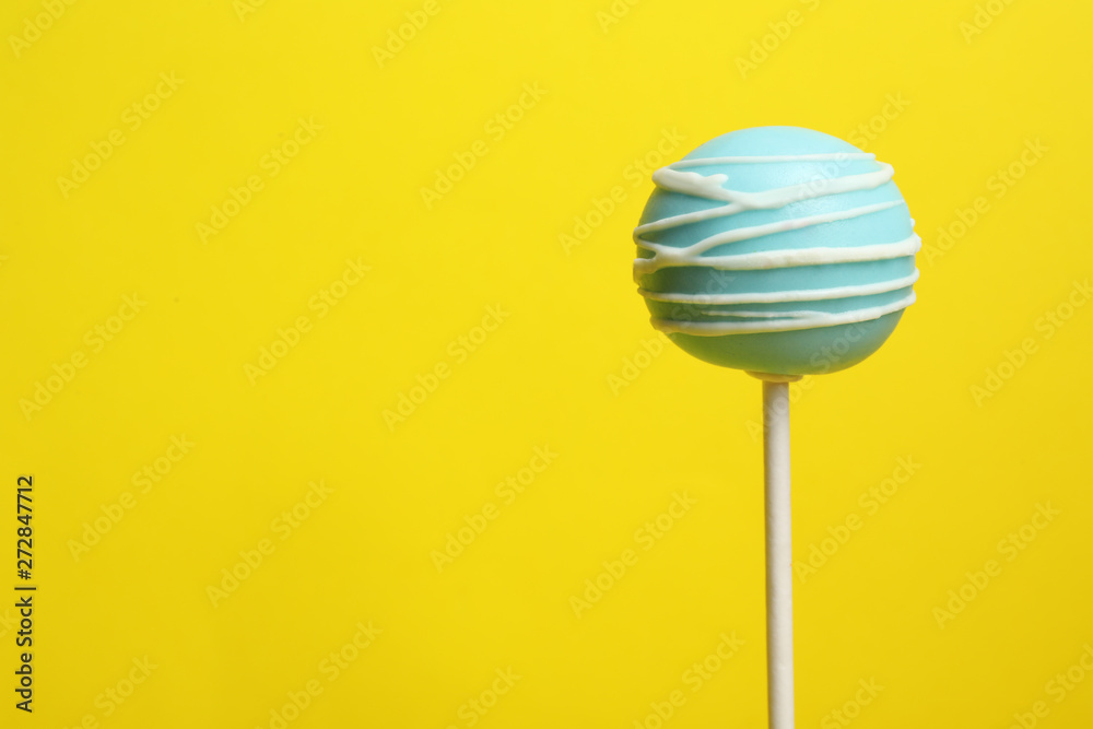 Bright delicious cake pop on color background. Space for text Bright delicious cake pop on color background. Space for text