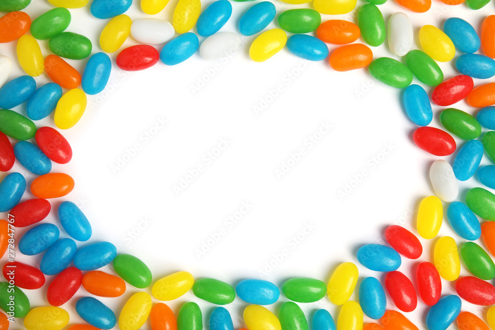 Frame of jelly beans on white background, top view. Space for text