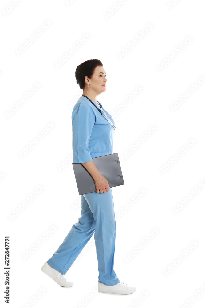 Full length portrait of female doctor in scrubs with clipboard isolated on white. Medical staff Full length portrait of female doctor in scrubs with clipboard isolated on white. Medical staff