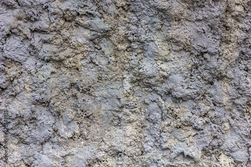 gray concrete wall with deep relief. rough surface texture