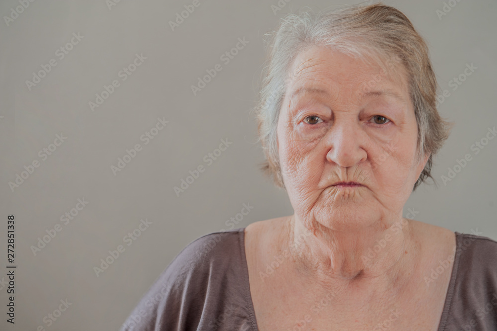 Health-conscious. Charming upbeat elderly lady working out with dumbbells and smiling pleasantly at the camera at home. Health-conscious. Charming upbeat elderly lady working out with dumbbells and smiling pleasantly at the camera at home.
