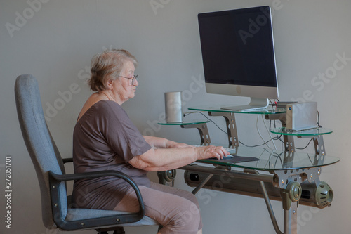 Pretty elderly woman received social assistance new computer last modification. Woman is very pleased. Pensioner can order medicines and products via Internet.
