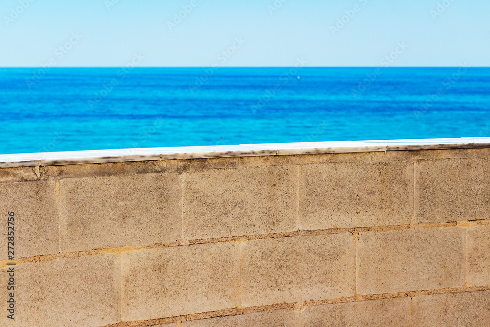 Fototapeta premium Blurred Mediterranean Sea view behind the Parque de la Bateria observation tower wall at Torremolinos, Province of Malaga, Andalusia, Spain