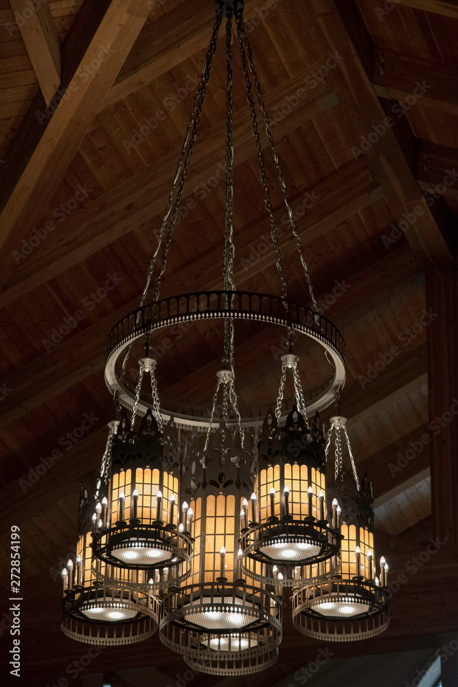 A LARGE CHANDELIER SUSPENDED FROM A CATHEDRAL CEILING