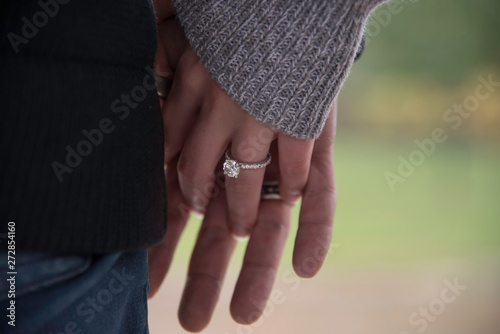 ENGAGED COUPLE HOLDING HANDS