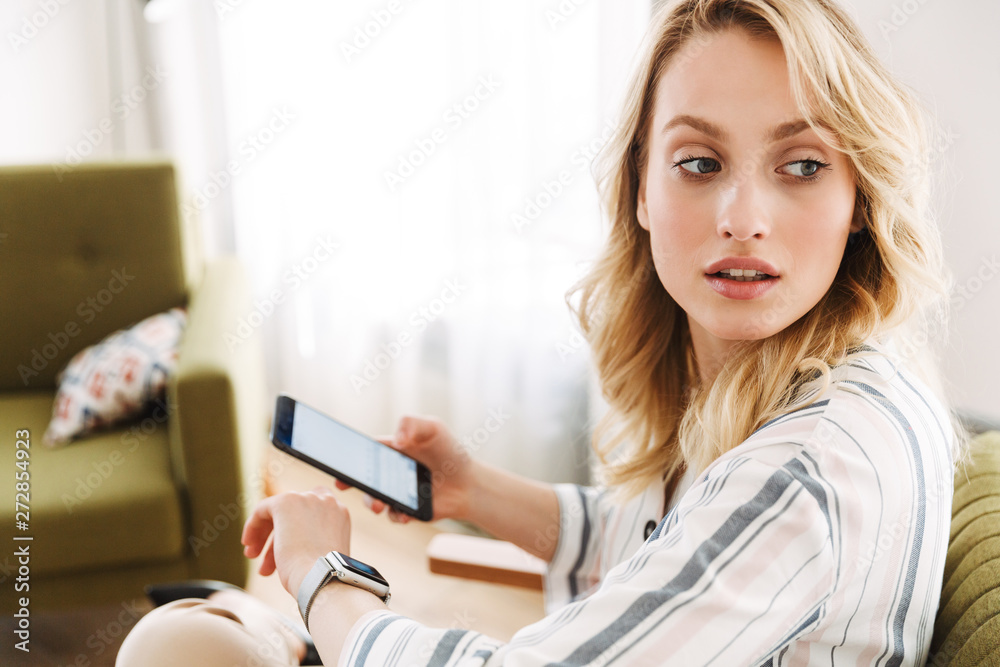 Beautiful young blonde woman sitting in armchair Beautiful young blonde woman sitting in armchair