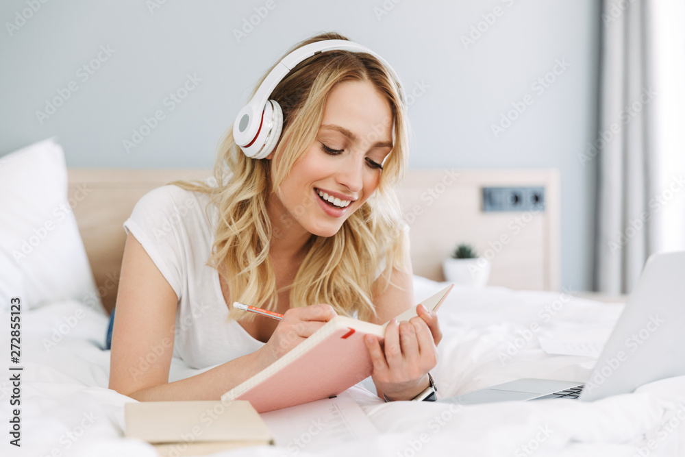 Beautiful young blonde woman relaxing in bed Beautiful young blonde woman relaxing in bed