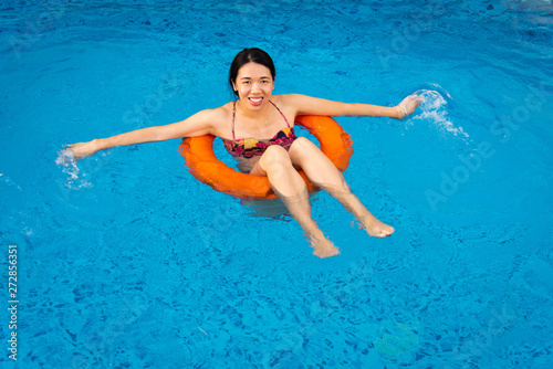 Girl enjoying at the swimming pool