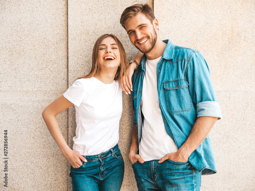 Portrait of smiling beautiful girl and her handsome boyfriend. Woman in casual summer jeans clothes. Happy cheerful family. Female having fun on the street background - obrazy, fototapety, plakaty 