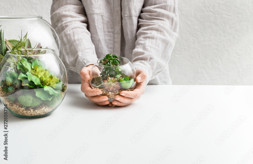 Woman holding mini glass florarium, copy space
