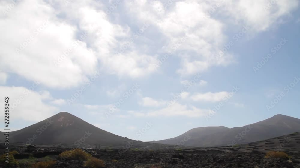 Whip Pan between volcanoes in vineyard in La Geria, Lanzarote, Spain Whip Pan between volcanoes in vineyard in La Geria, Lanzarote, Spain