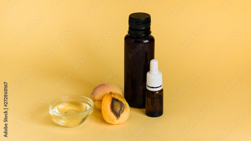 apricot and apricot seed oil on an orange background
