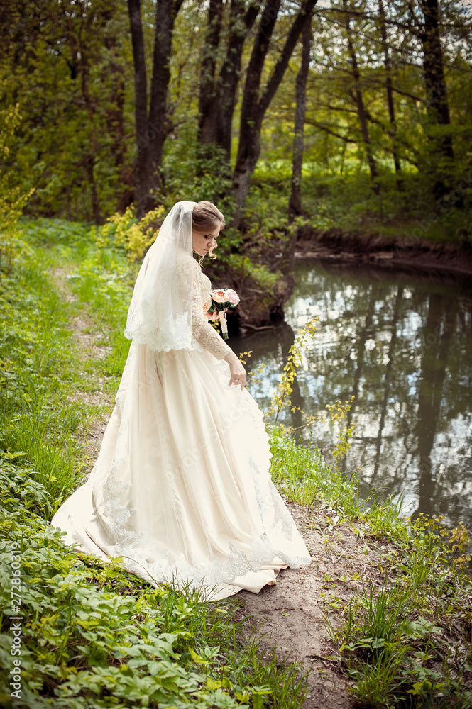 Bride in a white dress on the background of nature. Wedding photography Bride in a white dress on the background of nature. Wedding photography