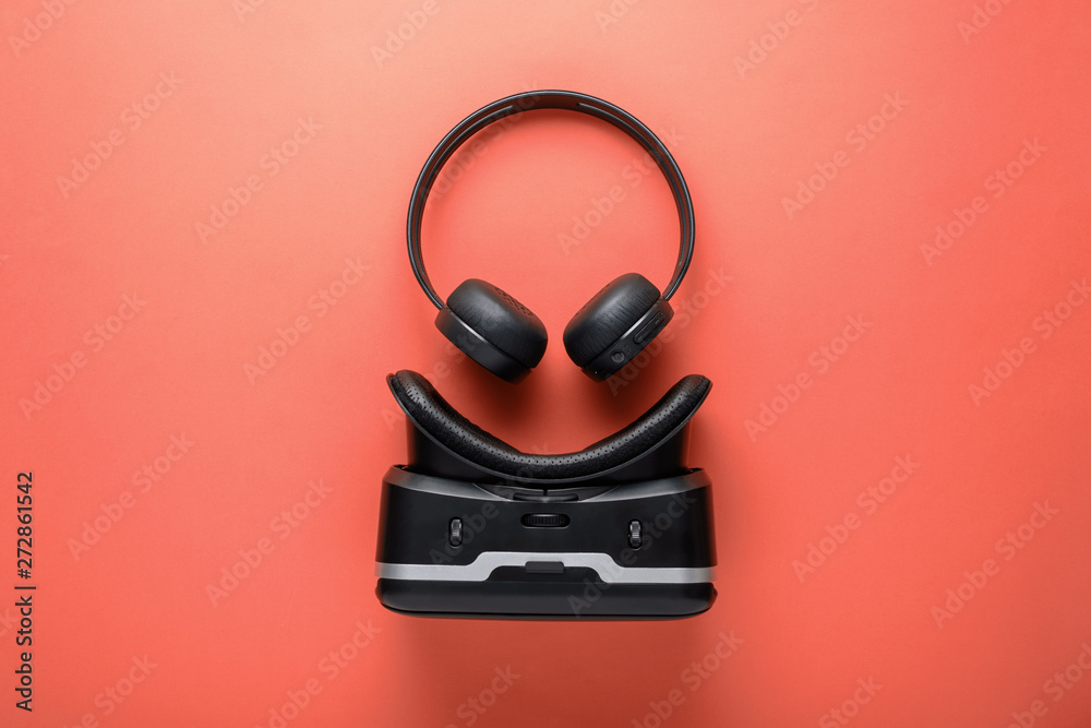 minimalistic design gadgets on red background, wireless headphones and VR glasses minimalistic design gadgets on red background, wireless headphones and VR glasses