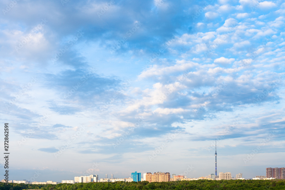 summer afternoon sky with clouds over city