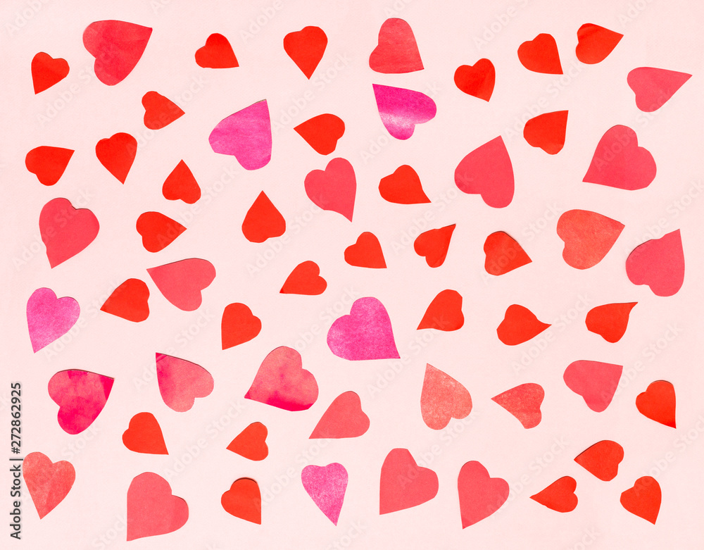 hearts cut from color papers on pink pastel paper