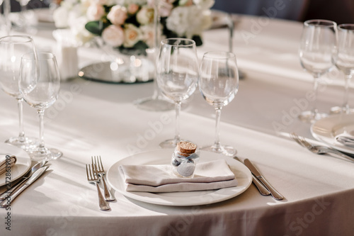 Wedding in the style vintage. Decoration of the table with flowers and cutlery. Composition from flowers. Elegant dining table in peach-purple color. Indoors wedding reception venue with festive decor