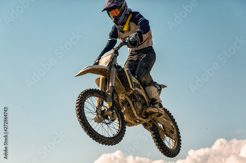 Fototapeta Naklejka Na Ścianę i Meble -  A picture of a biker making a stunt and jumps in the air