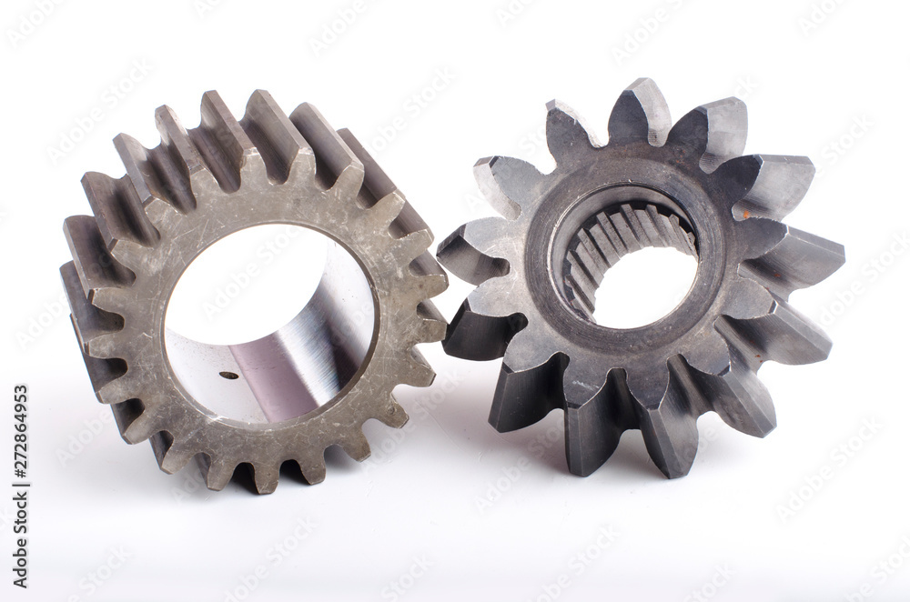 Small group of gears with their teeth engaged on a white background Small group of gears with their teeth engaged on a white background