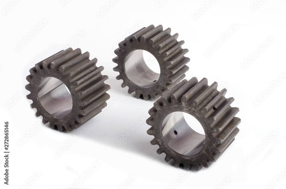 Small group of gears with their teeth engaged on a white background Small group of gears with their teeth engaged on a white background