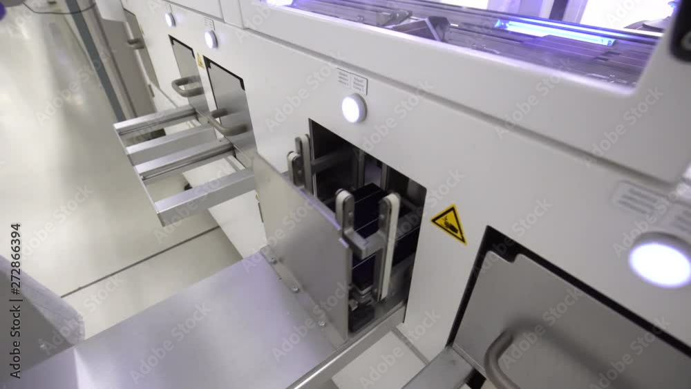 Worker hands in gloves insert solar module cells into mechanic column Worker hands in gloves insert solar module cells into mechanic column