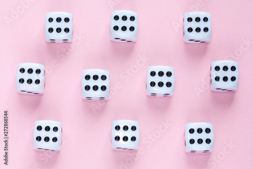 Gaming dices on pink background.
