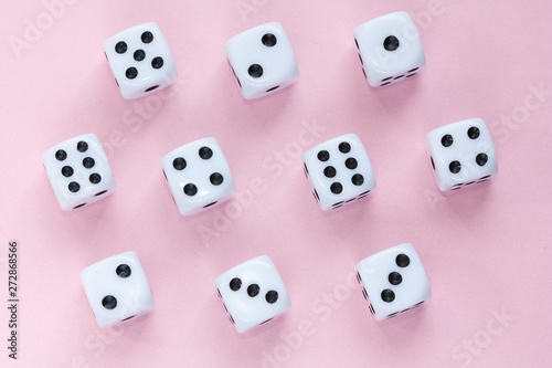 Gaming dices on pink background.