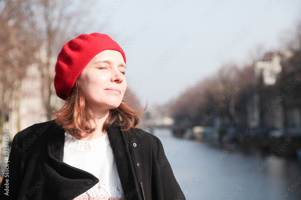 Young woman enjoying spring sunny on the bridge in Amsterdam, Young woman enjoying spring sunny on the bridge in Amsterdam,